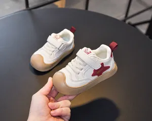 Detail of kids white sneaker with reinforced rubber toe cap and Velcro closure