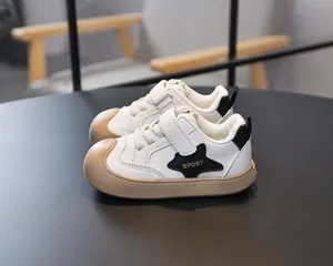 Detailed side view of kids sneakers featuring a star motif and velcro straps
