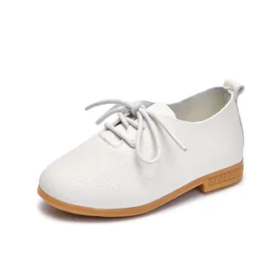 White leather kids oxford shoes with brown rubber sole in a classic 45-degree angle view