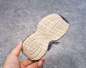Detailed view of beige non-slip outsole texture on children athletic sneakers