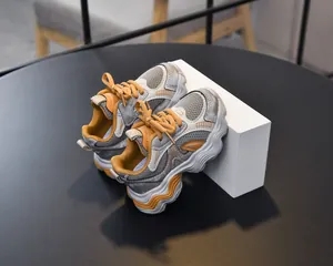 Close-up of grey mesh and orange lining detail on girls breathable chunky sneakers