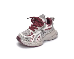Detail view of children sports shoes with breathable mesh and burgundy laces