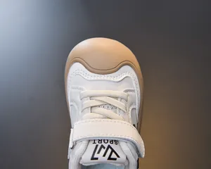 Close-up of kids sports sneakers showing durable toe cap and secure magic tape closure