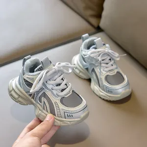 Detailed close-up of breathable mesh and synthetic leather paneling on children's sneakers