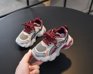 Detail of girls' breathable mesh sneakers featuring grey and burgundy patchwork design