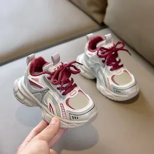 Detail of kids' thick-soled chunky sneakers with warm fleece lining and mesh upper