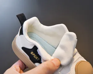 Detail of breathable mesh lining and reinforced padded collar of kids sports sneakers