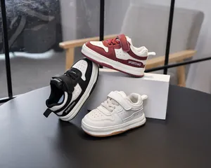 Detail of toddler sneakers with velcro straps and breathable holes in three colors
