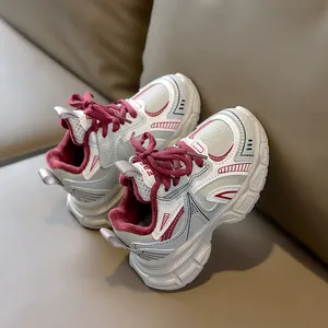 Macro view of children's winter sneakers showing burgundy faux fur lining and mesh upper