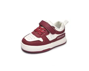 Detail of red and white toddler sneakers with velcro straps and breathable toe holes
