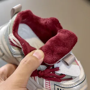 Detailed view of kids' sneakers featuring warm thick red fleece lining for winter comfort
