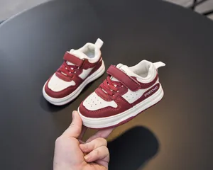 Close-up of children sneakers featuring velcro straps and breathable toe perforations