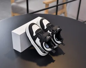 Detail of toddler sports sneakers with black and white color block and velcro strap