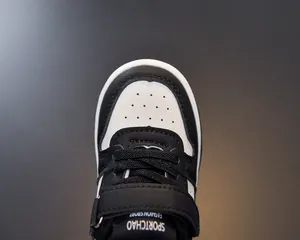 Detailed close-up of kids' leather sneakers featuring breathable toe box and velcro strap