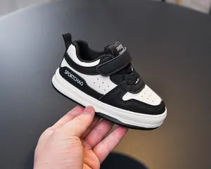 Close-up detail of the black and white toddler walking sneakers with Velcro straps