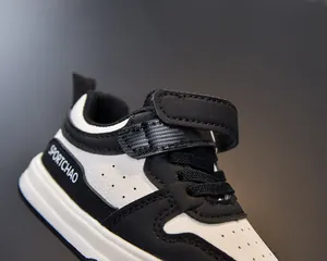 Detail of kids sneaker with breathable toe holes and hook-and-loop strap closure