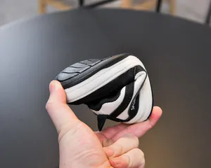 Detail showing the flexible sole and soft material of these children's sports shoes