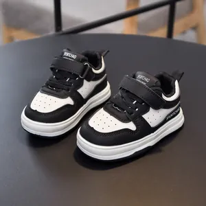 Classic black and white toddler sneakers with velcro straps and breathable mesh
