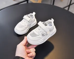 Detail of white kids sneaker showing breathable mesh and convenient velcro strap closure