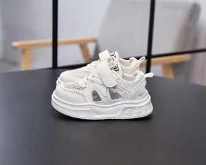 Detail view of children's ivory sports sandals featuring breathable mesh and velcro straps