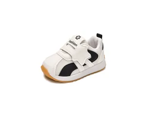 Detail view of breathable mesh kids sneakers with black accents and gum rubber outsole