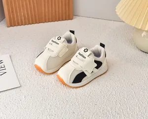 Detailed close-up of breathable mesh fabric and orange non-slip sole on kids sneakers