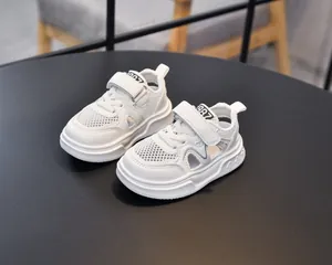 Detail view of white kids sports sandals with breathable mesh and 1987 logo on tongue