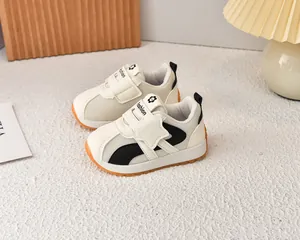 Detailed close-up of breathable mesh kids sneakers with orange gum sole and velcro straps