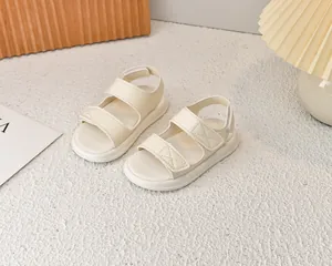 Dettaglio di sandali crema per bambini con doppio velcro e suole morbide spesse