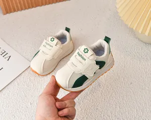 Detail view of breathable mesh kids sneakers with hook-and-loop closure and floral logo