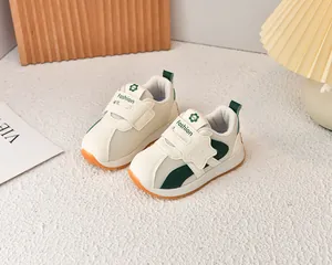 Detail of breathable mesh children shoes with orange non-slip sole and velcro strap