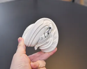 Detail of flexible soft white kids sports sandal showing highly bendable rubber sole