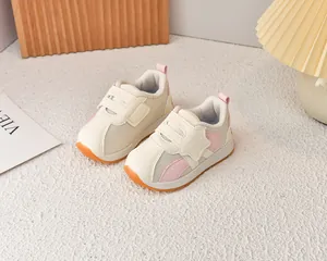 Detail of toddler mesh sneakers with beige leather panels and pink star Velcro straps