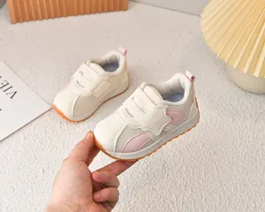 Detail of pink mesh kids sneakers featuring dual velcro straps and non-slip rubber sole