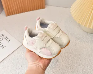 Detail of toddler mesh sneakers showing beige and pink patchwork and velcro closure