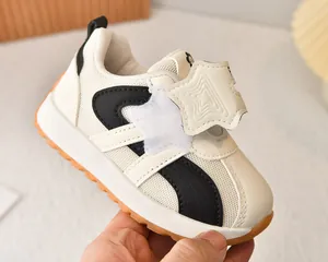 Detail of toddler sports shoes with breathable mesh and orange non-slip rubber sole