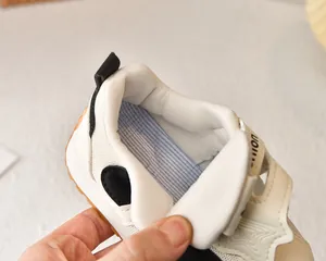 Detail view of breathable mesh lining and striped insole of the kids' sneaker