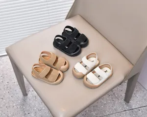 Detailed view of baby sandals in black, khaki, and beige with protective closed toe design