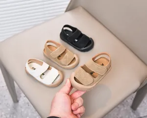 Detailed view of closed-toe baby sandals in white, khaki, and brown with velcro straps