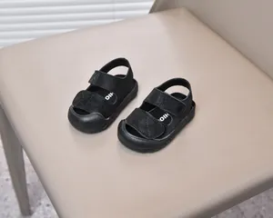 Detail of baby anti-collision sandals with double hook-and-loop straps on a chair