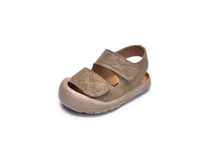 Detailed top-side view of brown baby sandals with rubber toe cap and velcro straps