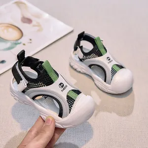 Detail of breathable mesh and protective toe cap on kids green sport sandals