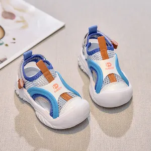 Detailed close-up of children's breathable mesh sandals with protective toe and velcro straps