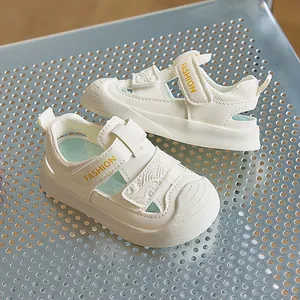 Close-up of cream toddler sandals with double velcro straps and protective toe caps