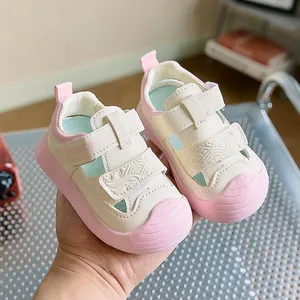 Close-up of beige and pink toddler sandals featuring velcro straps and anti-collision toe