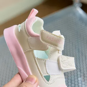 Detail of pink and beige toddler sandals with breathable mesh and dual velcro straps