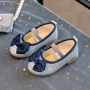 Top view of sparkling blue sequin girls Mary Jane shoes with navy ribbon bow detail