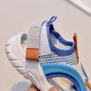Detail view of the breathable mesh texture and blue-orange stitching on kids' sports sandals