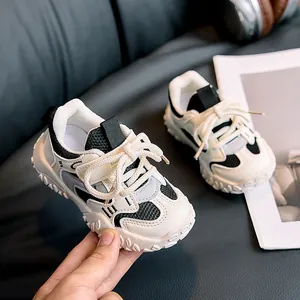 Close-up of kids tricolor chunky sneakers with mesh fabric and thick anti-slip soles