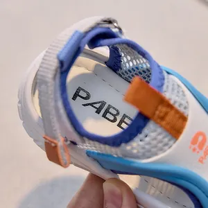 Detail view of the breathable mesh and adjustable velcro strap on kids' sports sandals